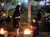 Iranians light candles on a street-side while attending a ceremony to commemorate Ashura, in northern Tehran on August 30, 2020, amid the ne...
