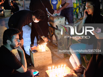 Iranian youth light candles while attending a ceremony to commemorate Ashura, in northern Tehran on August 30, 2020, amid the new coronaviru...