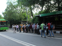 Commuters queue to board DTC buses at Raj Ghat Power House near Delhi Secretariat on August 31, 2020 in New Delhi. India is fast becoming th...