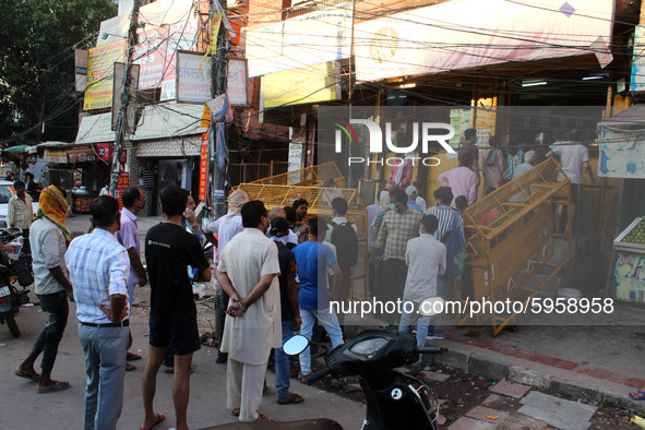 People queue outside a liquor store, flouting social distance, at School Block, Laxmi Nagar on August 31, 2020 in New Delhi. India is fast b...