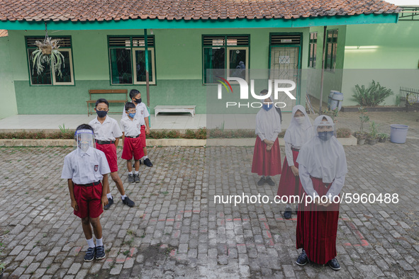 Students line up before entering the classroom at Candirejo Elementary School, Semarang Regency, Central Java, Indonesia, on September 1, 20...