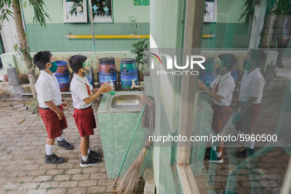 A student wash his hands before entering the classroom at Candirejo Elementary School, Semarang Regency, Central Java, Indonesia, on Septemb...