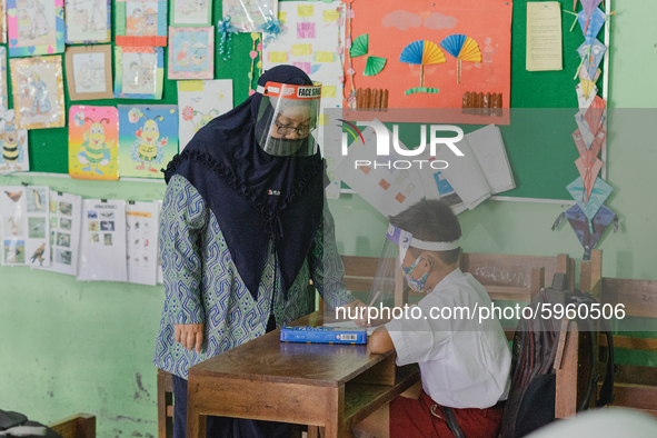 A teacher give explanation to a student at Candirejo Elementary School, Semarang Regency, Central Java, Indonesia, on September 1, 2020. Loc...