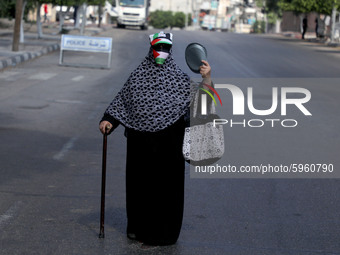  A Palestinian woman covers her face with a Palestinian flag amid the ongoing coronavirus COVID-19 pandemic in Gaza City, September 1, 2020....