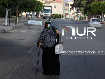  A Palestinian woman covers her face with a Palestinian flag amid the ongoing coronavirus COVID-19 pandemic in Gaza City, September 1, 2020....