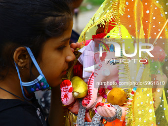 A Hindu devotee prays in the ear of an idol of Hindu elephant-headed deity Ganesh before immersing in a pond during the Ganesh Chaturthi fes...