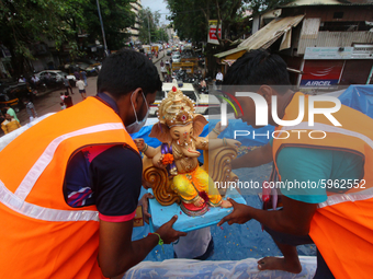 Volunteers carry an idol of the Hindu god Ganesha, to immerse it in a tank atop a truck during the final day of the Ganesh Chaturthi festiva...