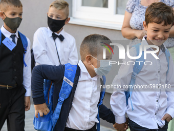 First graders wear protective face masks during a ceremony to mark the start of the new school year, amid the outbreak of the coronavirus di...