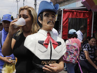 Devotees of Santa Muerte in Tepito, also known as ''Nina Blanca'', carry a busti of Jesus Malverde to thank him for the favors carried out d...