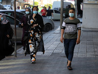 Palestinians wearing face masks walk on a street in Gaza City on September 2, 2020 during a lock down in the Palestinian enclave due to incr...