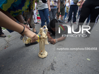 Devotees of Santa Muerte attend to ask for a command and ask her for a favor, so kneeling, with flowers and candles, they arrive at her alta...