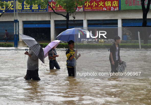 GUILIN, May 20, 2015 () -- People walk on a flooded street in Guilin, south China's Guangxi Zhuang Autonomous Region, May 20, 2015. As heavy...