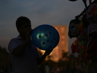 A street hawker blowing balloon at a park in Dhaka, Bangladesh on September 4, 2020.  (