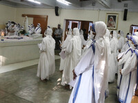 Nuns from the Catholic Order of the Missionaries of Charity wearing facemasks pray at the tomb of Mother Teresa to mark her 23rd Death Anniv...
