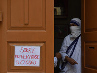 A catholic nun seen wearing face mask from the Missionaries of Charity, the global order of nuns founded by Saint Mother Teresa stands at th...