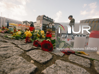 A young kid stands behind the flowers, candles at neumarket in Solingen, Germany, on September 5, 2020 (