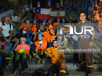 Chilean rescue team called ''Topos'' on a group photo with some members of the Lebanese Civil Defense after they finish the rescue operation...
