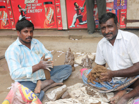 Tamil artisans creating small clay idols of Lord Ganesha (Lord Ganesh) along the roadside during the festival of Ganesh Chaturthi in Pondich...