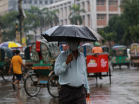 A man holds umbrella as he walking during rainfall in Dhaka, Bangladesh on September 8, 2020.  (