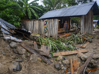 A mother is inside her house which was damaged by the flood in Oloboju Village, Sigi Regency, Central Sulawesi Province, Indonesia on 9 Sept...