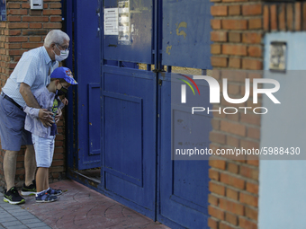 An old man and his grandchild wearing facemasks during the first day of school on September 10, 2020 in Granada, Spain.  (
