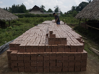 Workers making bricks in Palembang, South Sumatra, Indonesia on June 30, 2020, then using machines. Sales of bricks in Palembang have droppe...