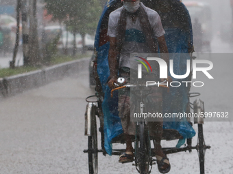 A man pulls rickshaw during the rainfall in Dhaka, Bangladesh on September 13, 2020. (