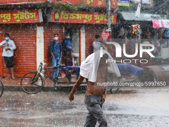 A man crossing road during the rainfall in Dhaka, Bangladesh on September 13, 2020. (