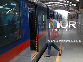 A Passenger wearing a face mask walk at the platform to board a train at Noyapara Metro Station as KOLKATA METRO RAIL CORPORATION  resume op...