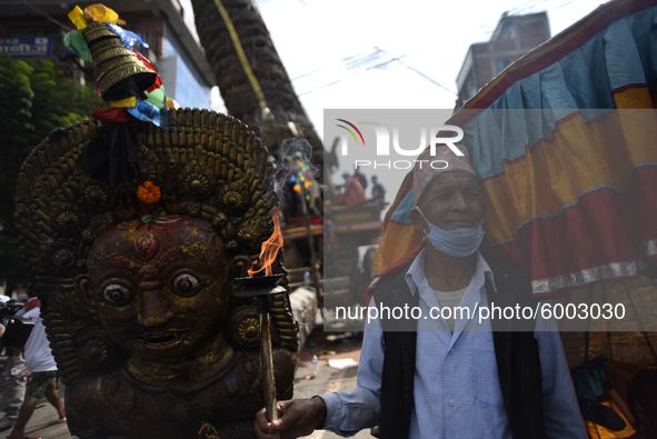 A devotee arrive along with torch to welcome idol Rato Machindranath on a last day at Pulchowk, Lalitpur, Nepal on Monday, September 14, 202...
