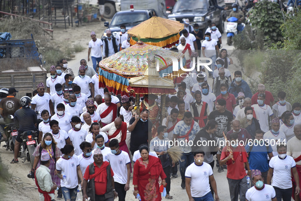 Nepalese devotees along with the face mask carrying the idol Rato Machindranath on a last day towards Bungamati from Pulchowk, Lalitpur, Nep...