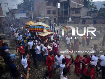 Nepalese devotees along with the face mask carrying the idol Rato Machindranath on a last day towards Bungamati from Pulchowk, Lalitpur, Nep...