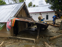 Residents are in front of their houses buried in mud due to flash floods in Rogo Village, Dolo Selatan District, Sigi Regency, Central Sulaw...