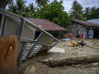 Residents are in front of their houses buried in mud due to flash floods in Rogo Village, Dolo Selatan District, Sigi Regency, Central Sulaw...