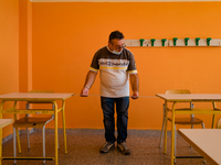 A janitor taking the measurement (1 meter) for the spacing of the classroom desks in the Don Tonino Bello High School in Molfetta on 16th Se...