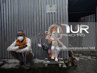 Shyam Narayan Pandit, a clay artist takes rest outside his workshop at Lalitpur, Nepal on Wednesday, September 16, 2020. Vishwakarma is the...