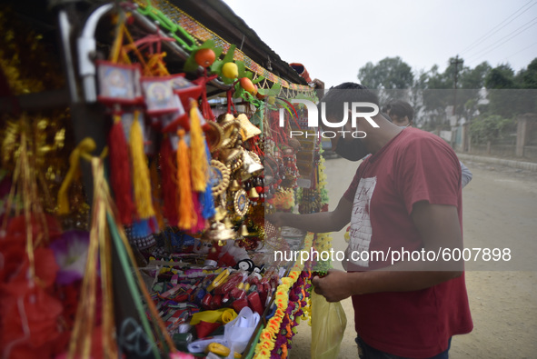 A man buying decorating materials for the Vishwakarma Puja at Lalitpur, Nepal on Wednesday, September 16, 2020. Vishwakarma is the deity of...