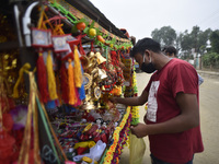 A man buying decorating materials for the Vishwakarma Puja at Lalitpur, Nepal on Wednesday, September 16, 2020. Vishwakarma is the deity of...