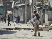 Kashmiri protesters clash with Indian Forces after the encounter ended in Batamaloo area of Srinagar, Indian Administered Kashmir on 17 Sept...