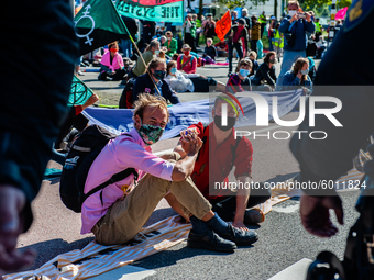 Some climate activists blocked the main road of the financial district by glued themselves during an act of peaceful civil disobedience. Wit...