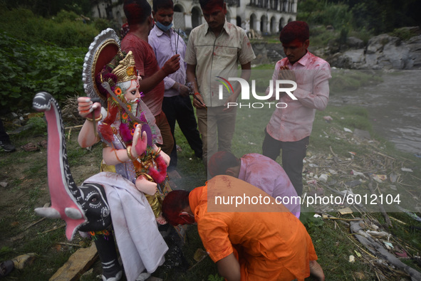 Nepalese Devotees offering fragrances stick before immerse the idol of lord Vishwakarma in the Bagmati river at Kathmandu, Nepal on Friday,...