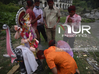 Nepalese Devotees offering fragrances stick before immerse the idol of lord Vishwakarma in the Bagmati river at Kathmandu, Nepal on Friday,...