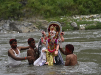 Nepalese Devotees immerse the idol of lord Vishwakarma in the Bagmati river at Kathmandu, Nepal Friday, September 18, 2020. Vishwakarma is t...