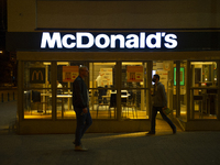 People walk by a McDonald's restaurant on September 18, 2020 in Warsaw, Poland. (