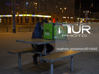A fast food delivery man checks his phone on September 18, 2020 in Warsaw, Poland. (