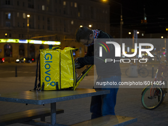 A fast food delivery man packs food in his delivery bag on September 18, 2020 in Warsaw, Poland. (