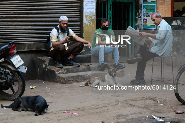 People passing their idle time on a street in Dhaka, Bangladesh on September 19, 2020.  