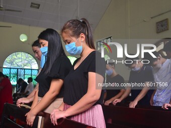 Christian worshiper wearing protective face mask inside a church pray as they attend a Sunday service amid Covid-19 at Mao Baptist Church in...