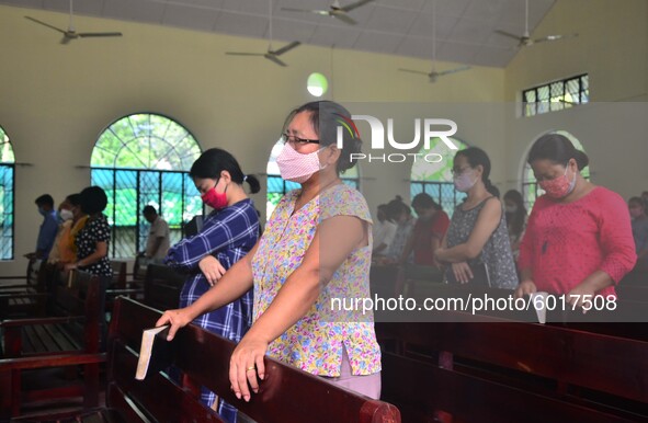 Christian worshiper wearing protective face mask inside a church pray as they attend a Sunday service amid Covid-19 at Mao Baptist Church in...