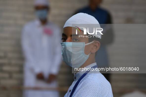 Muslim boy wearing a face mask takes part in Annual Conference amid COVID-19 (coronavirus) Pandemic Held at Jamia Islamia Quran in Sopore, D...